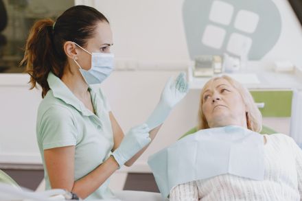 Elderly Woman Lying in a Dentist Room